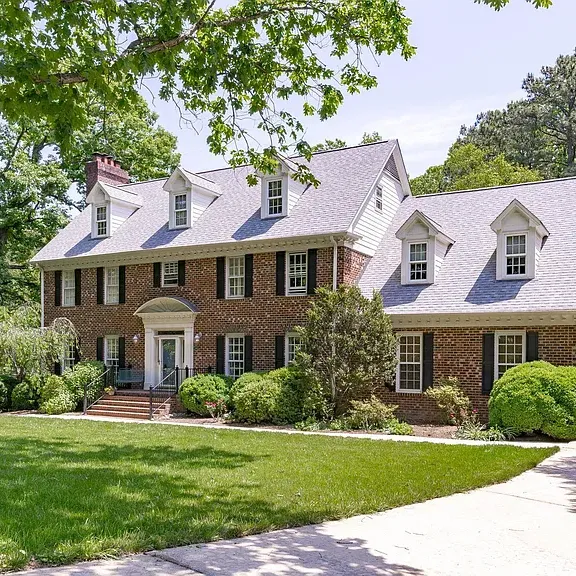 Traditional brick home with white trim